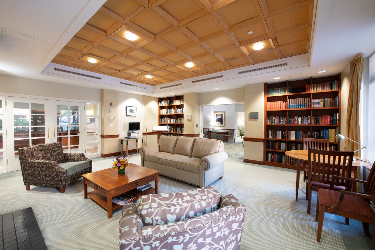 A cozy library interior with comfortable seating and bookshelves.