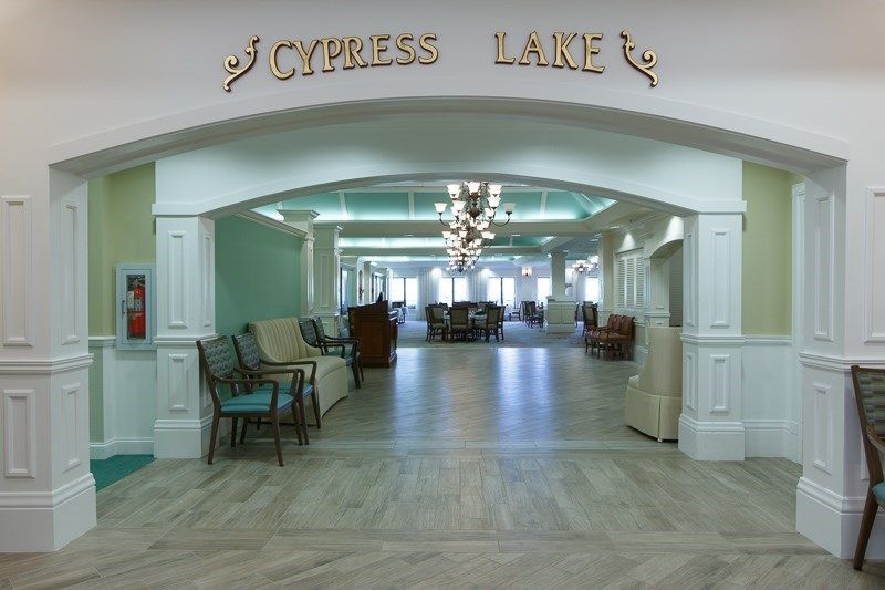Elegant lobby entrance with seating and chandelier at Cypress Lake.