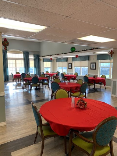 A spacious dining area set up with red tablecloths, ready for an event or gathering.