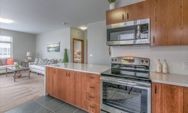 A modern kitchen featuring sleek appliances and a wooden countertop.