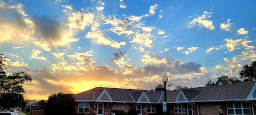 A beautiful sunset painting the sky with warm colors behind charming buildings.