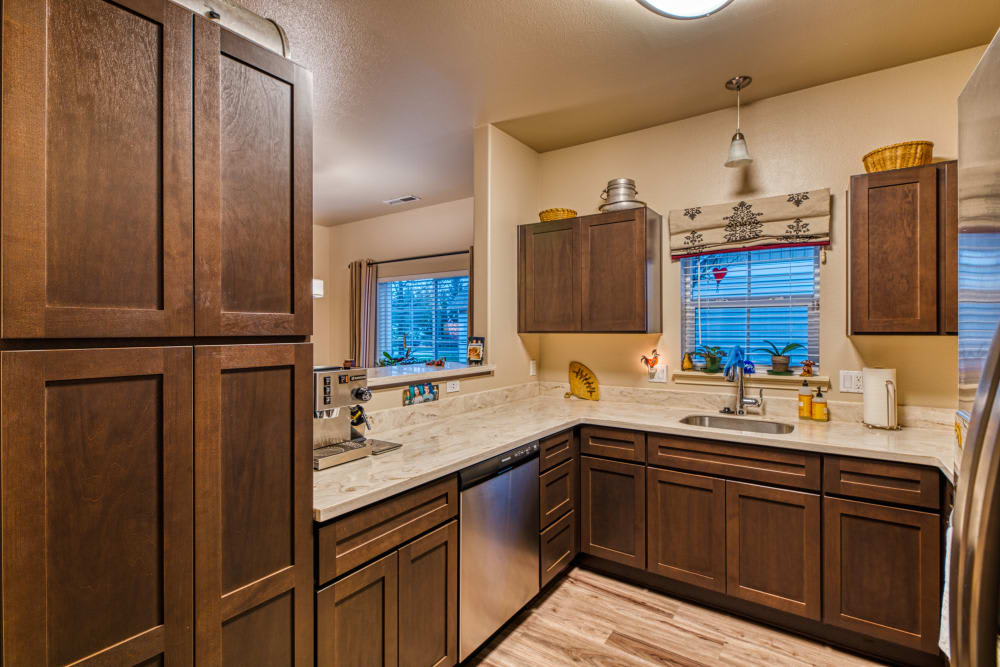 A modern kitchen with dark wooden cabinets and a spacious countertop.