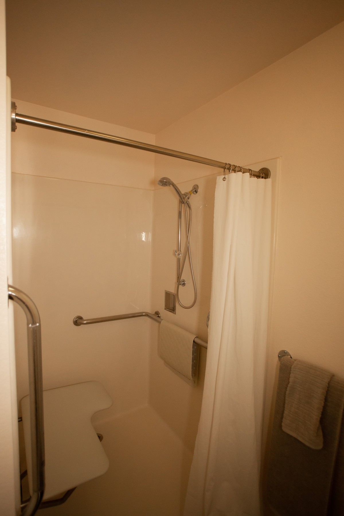 Accessible bathroom with a shower and grab bars.
