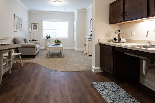A bright and spacious living area featuring modern furniture and a seamless transition to the kitchen.