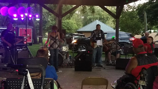 A lively outdoor concert featuring a local band performing for an engaged audience.