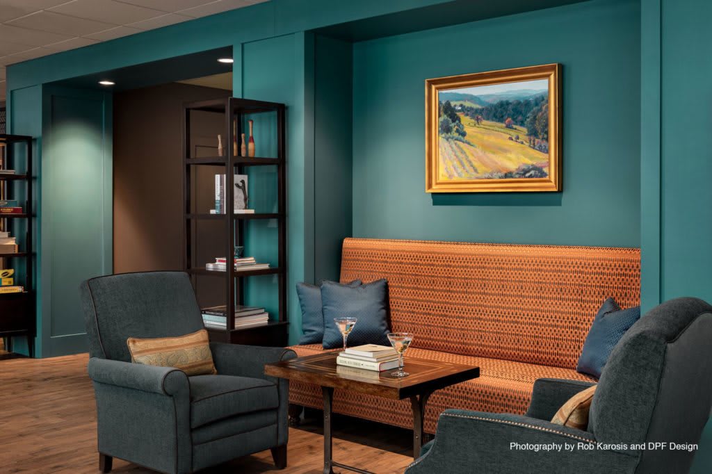 Cozy living room with plush seating and colorful artwork.