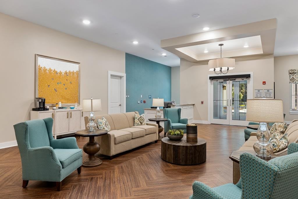 A modern living room with elegant furniture and warm lighting.