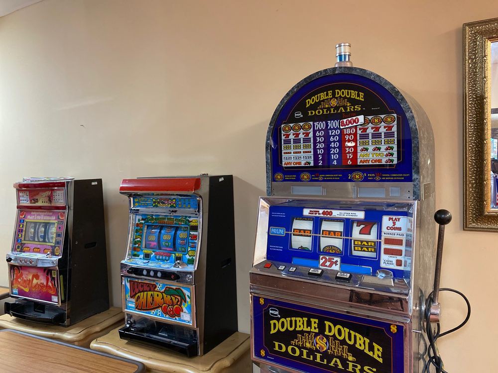 Two casino slot machines placed side by side in a gaming area.
