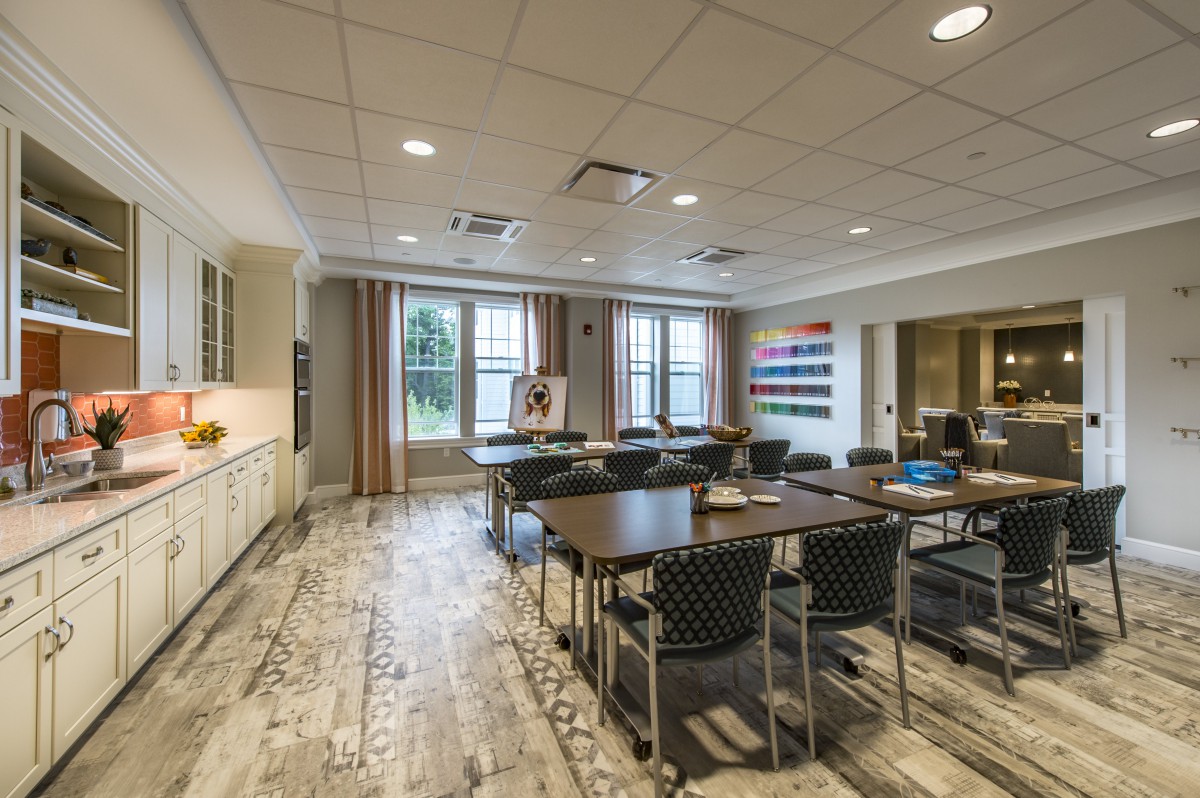 A modern conference room with tables and chairs arranged for a meeting.