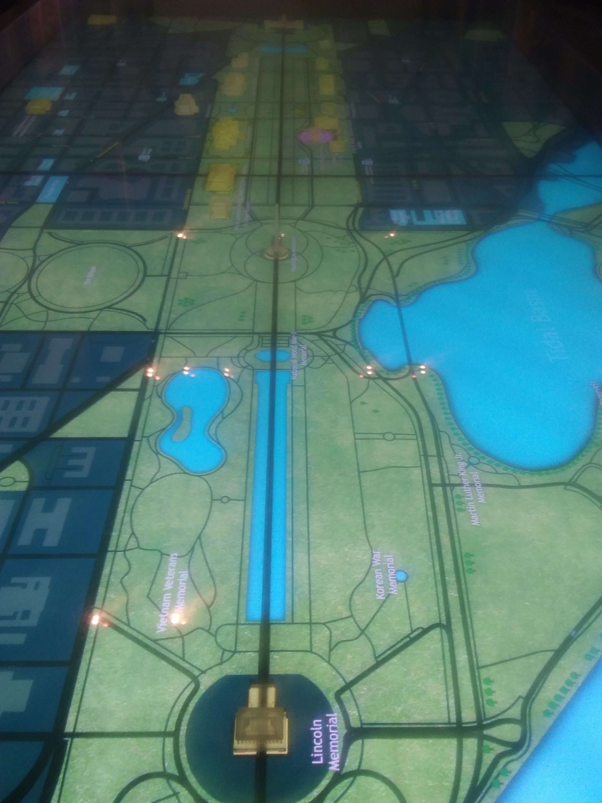 A floor map depicting an urban area with pathways, bodies of water, and architectural layouts.