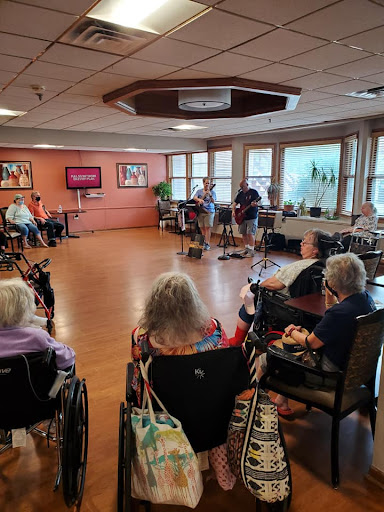 Residents enjoying a live music performance in the activity room.