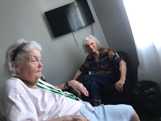 Two elderly women sitting in a living room.