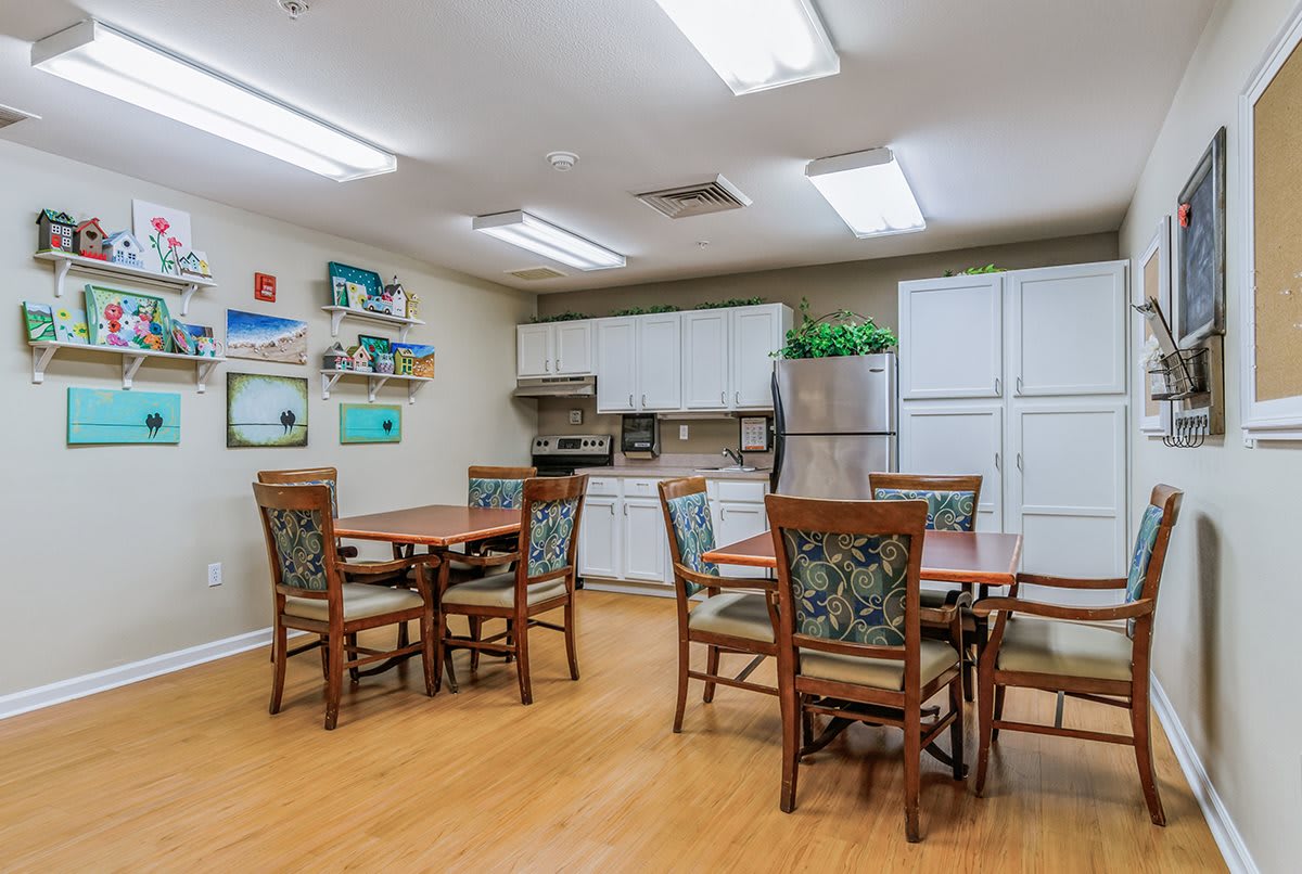 A cozy dining and kitchen area with tables, chairs, and modern amenities.