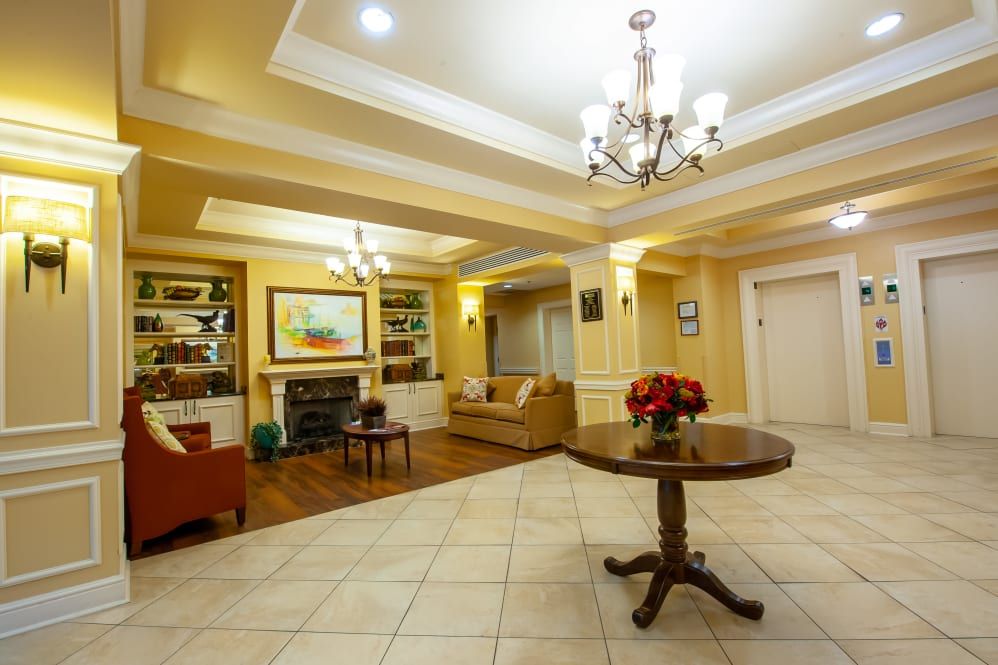 A well-lit lobby area with comfortable seating, a central table, and elegant decor.