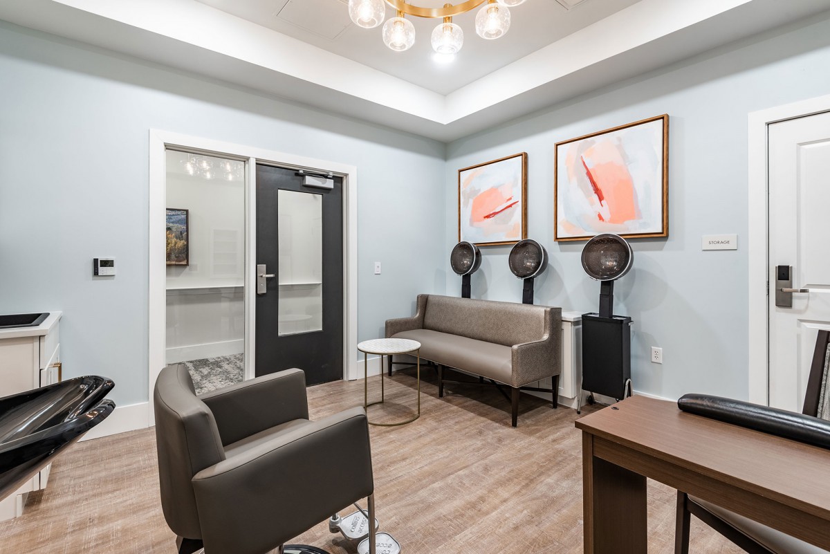 A modern salon waiting area with comfortable seating and stylish decor.