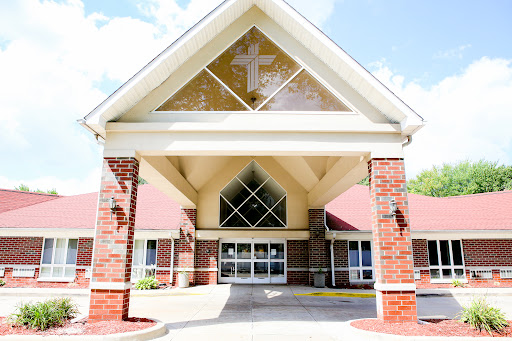 A welcoming church entrance featuring a prominent cross.