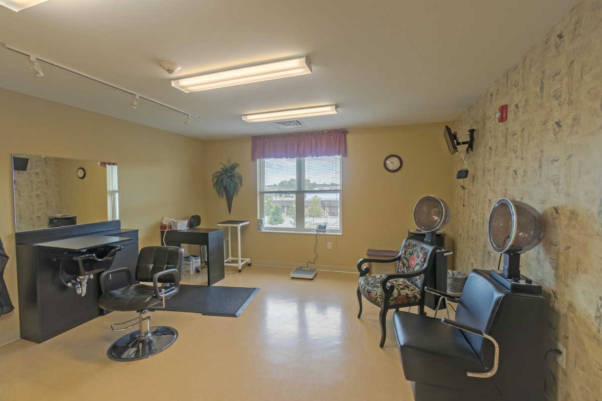 Interior of a hair salon with styling stations and chairs.