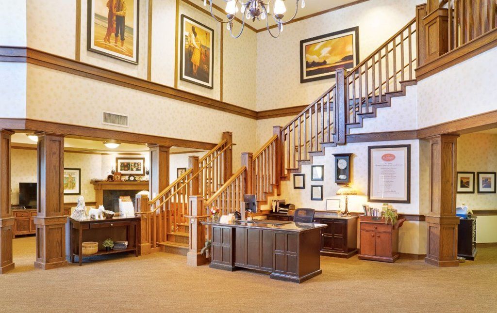 A welcoming lobby area featuring wooden stairs and decorative artwork on the walls.