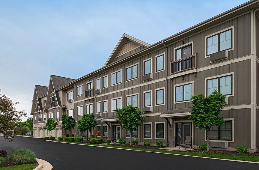 A row of modern townhouses with a clean, contemporary design lining a quiet street.