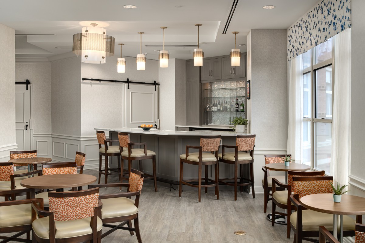 A modern dining area with a bar counter and stylish lighting.