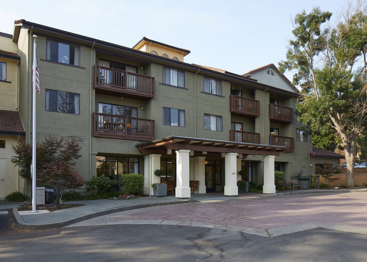 A residential apartment building with balconies and a welcoming entrance.