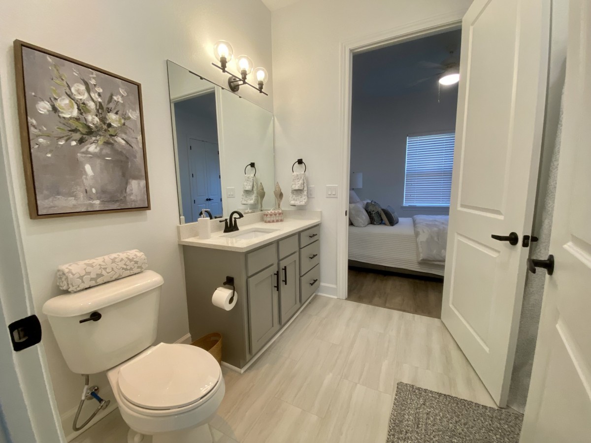 A modern bathroom with a double sink, large mirror, and neutral decor.