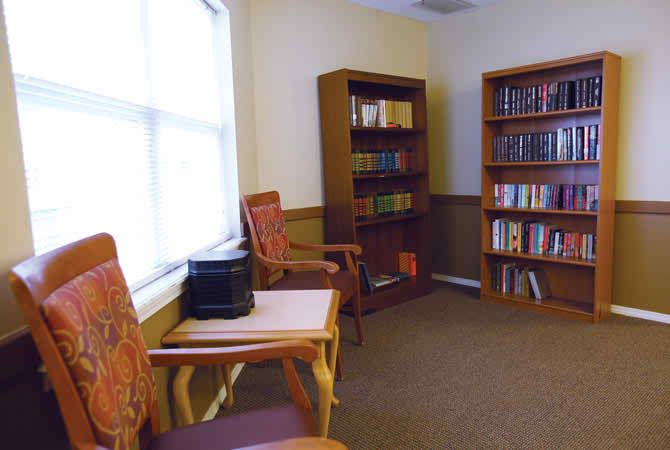 A cozy library corner with bookshelves and comfortable seating for reading.
