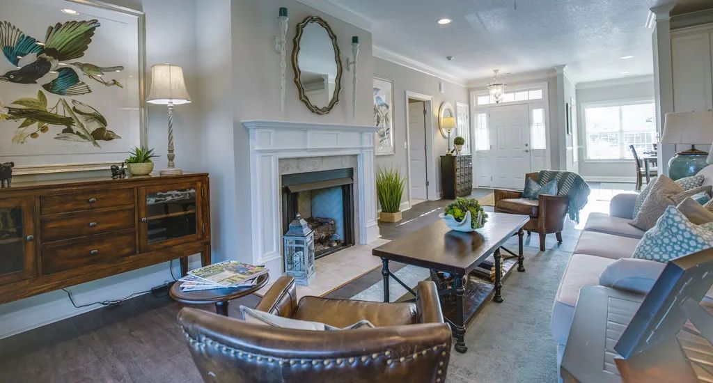A cozy living room with elegant furniture and a classic fireplace.