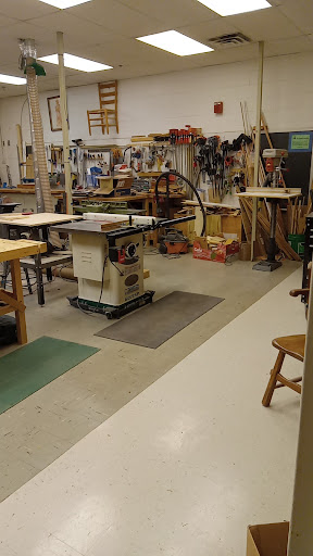 A well-equipped woodworking workshop featuring various tools and equipment.