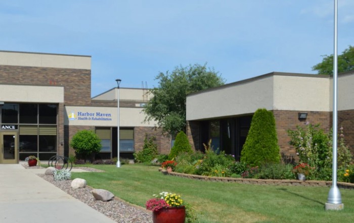 A healthcare facility with a landscaped exterior and modern architecture.