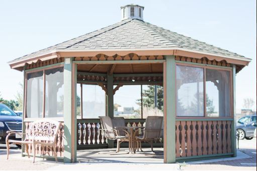 A charming gazebo featuring comfortable seating, perfect for enjoying the outdoors.