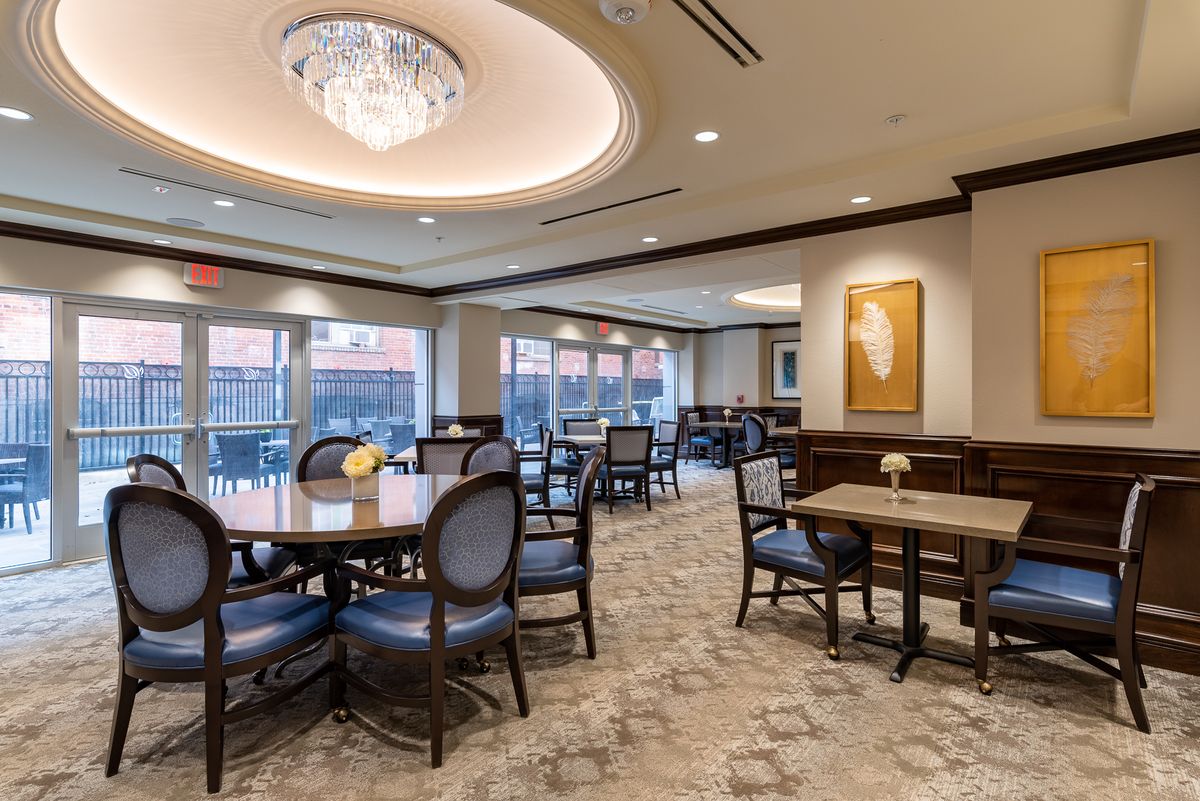 An elegant dining area with a chandelier and comfortable seating.