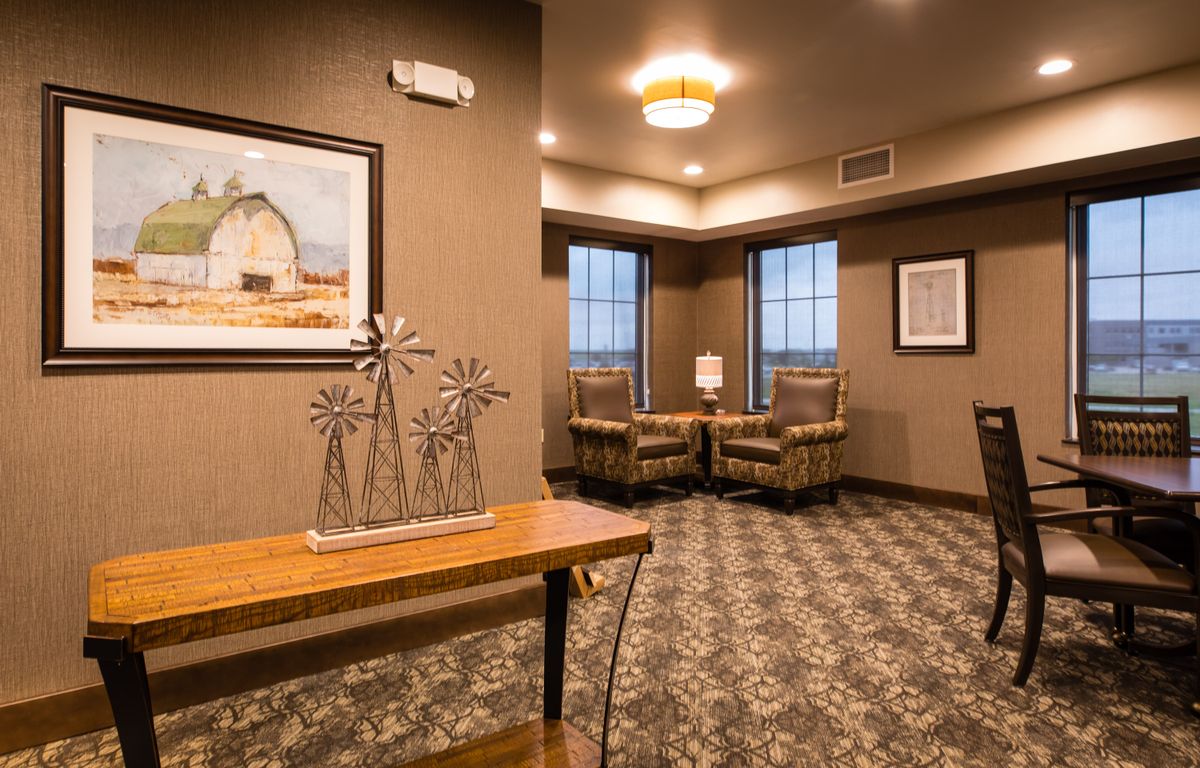 A cozy waiting area featuring comfortable seating and decorative artwork.