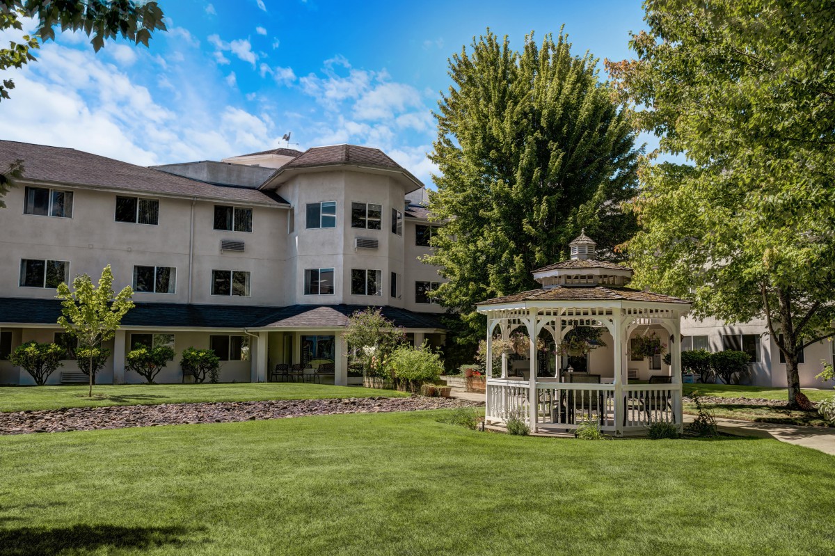 A scenic view of a building with a gazebo and landscaped garden.