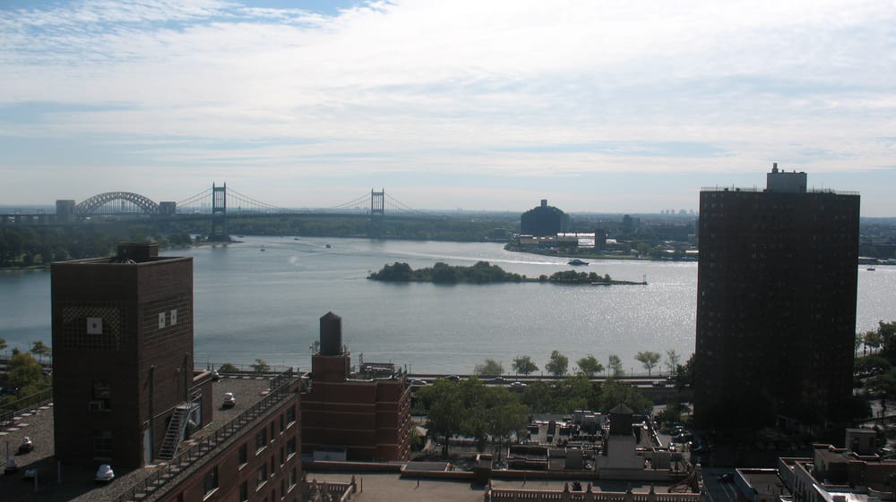 A view of the city skyline with a river, bridges, and small islands.