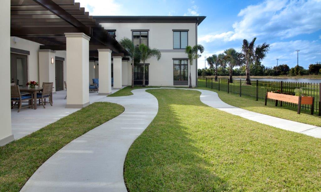 A modern house with a winding pathway and well-maintained grassy lawn.