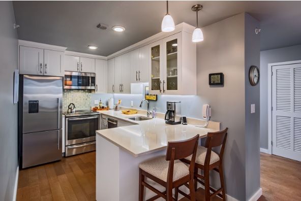 A modern kitchen with sleek appliances and a cozy breakfast bar.