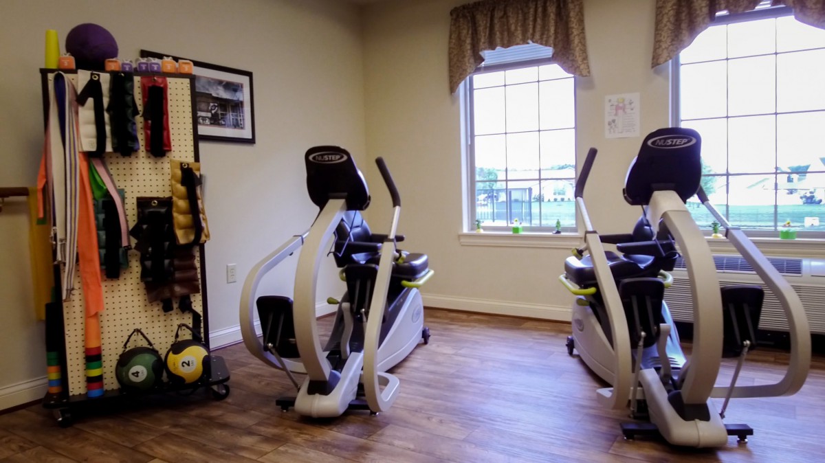 A small fitness room with recumbent exercise bikes and a window view.
