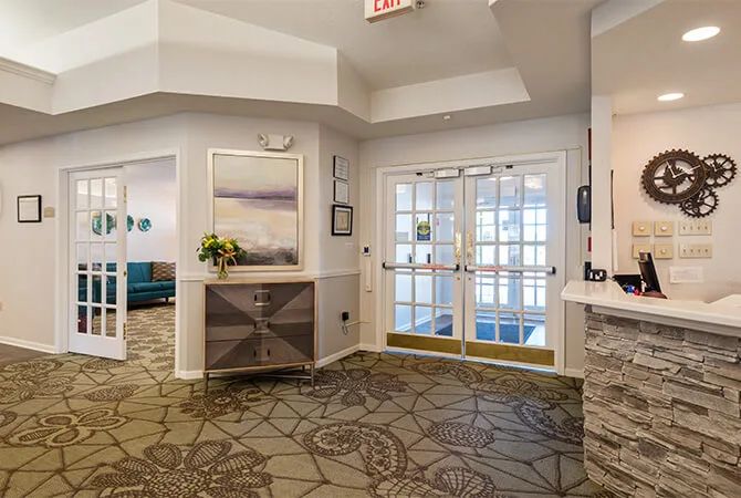 A modern lobby entrance with stylish decor and carpeting.
