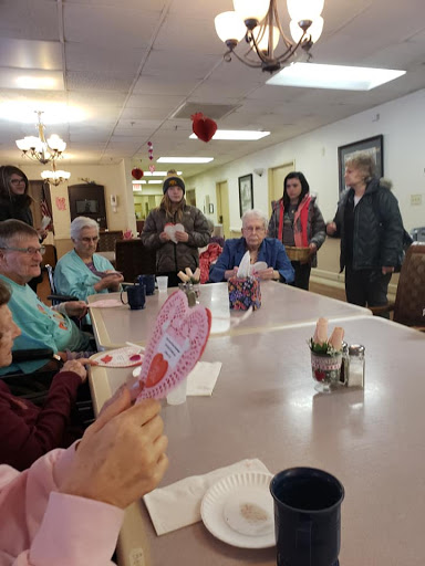 Residents engage in a crafting activity at their community center.