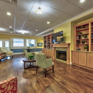 A cozy living room with a fireplace, TV, and comfortable seating.