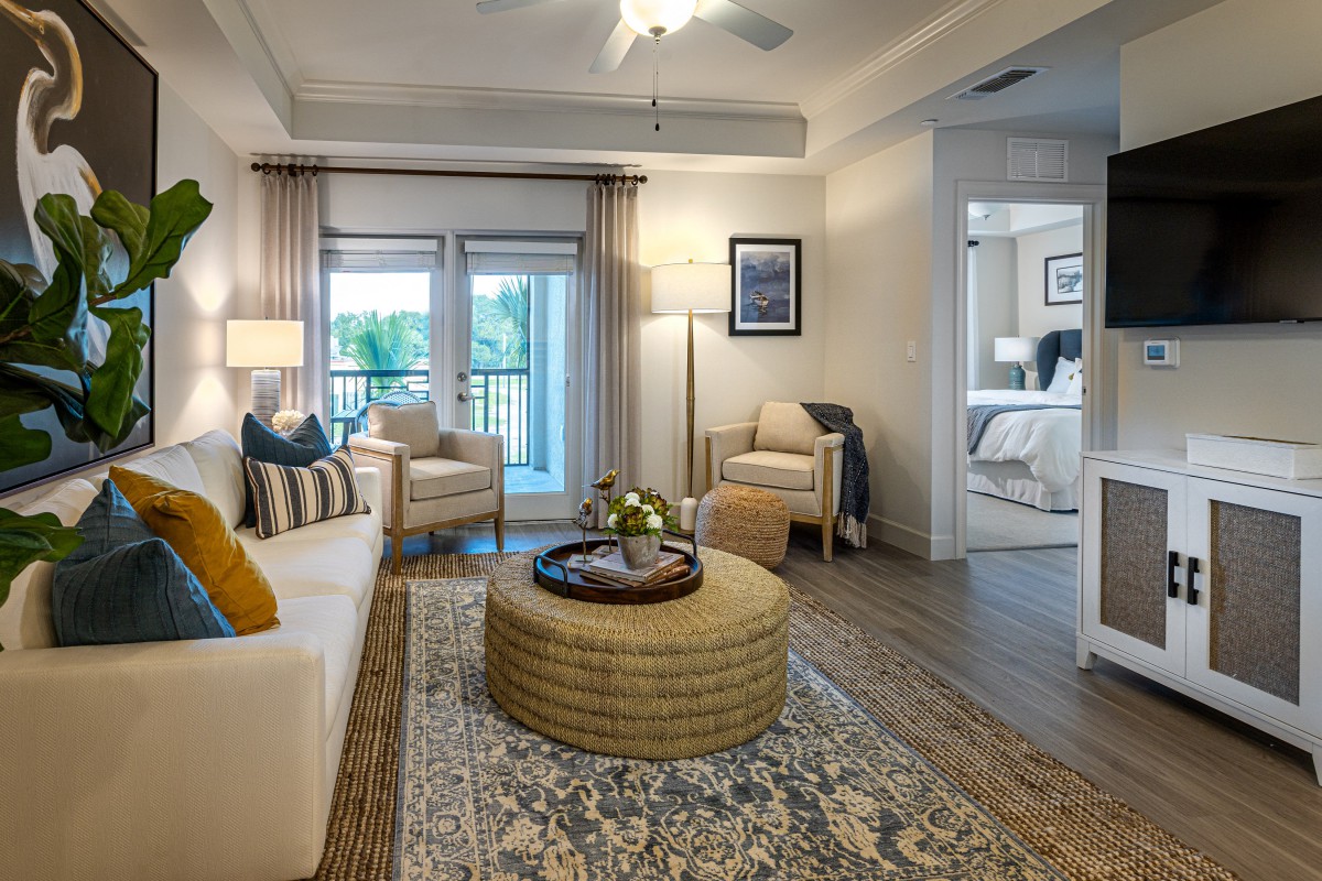 A modern living room with cozy furnishings and abundant natural light.