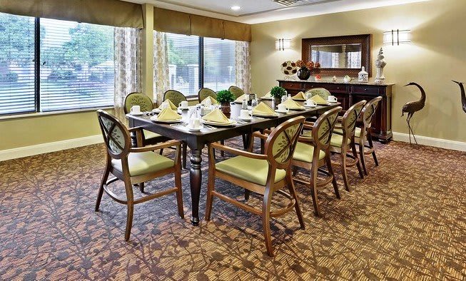 A well-arranged dining room with a set table and elegant decor.