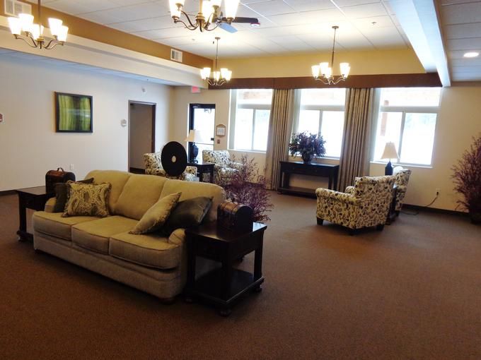 A spacious living room with elegant furnishings and soft lighting.