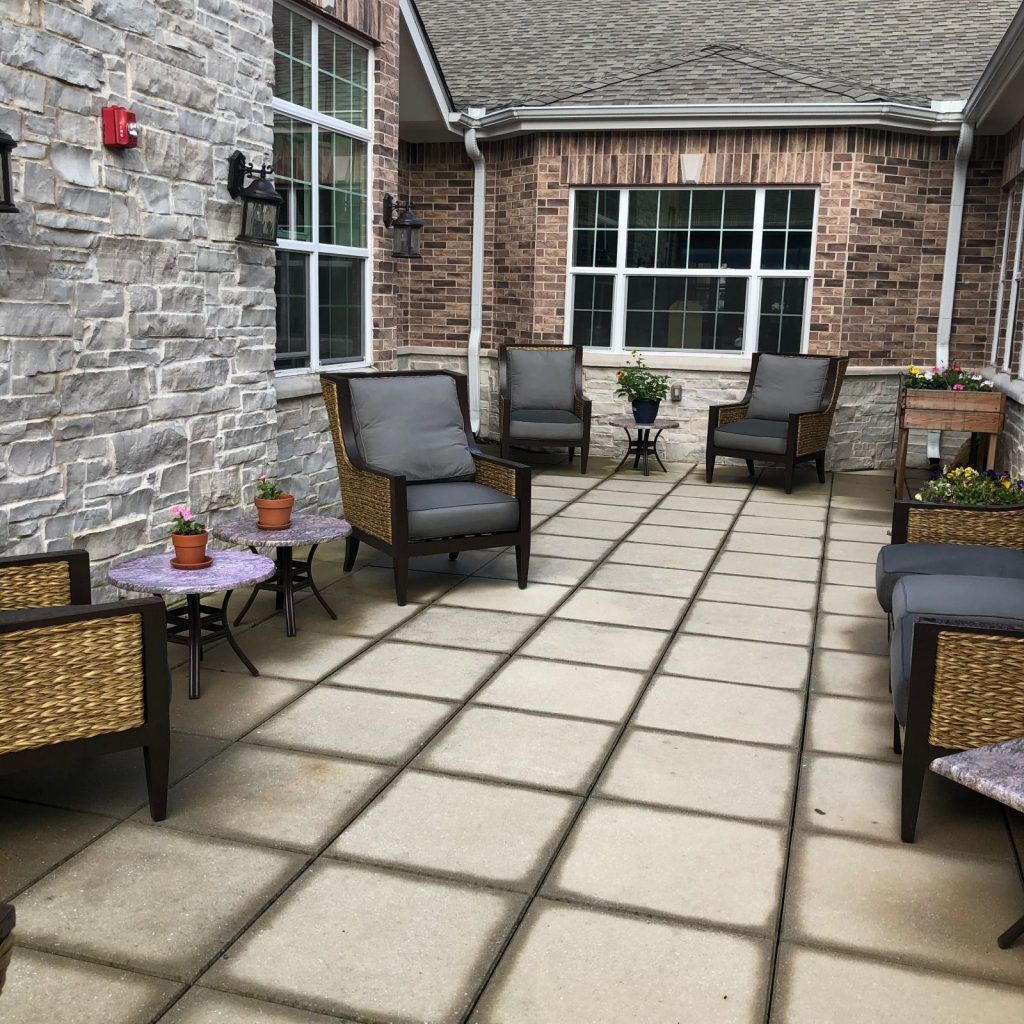 An outdoor patio area with comfortable seating and small tables.
