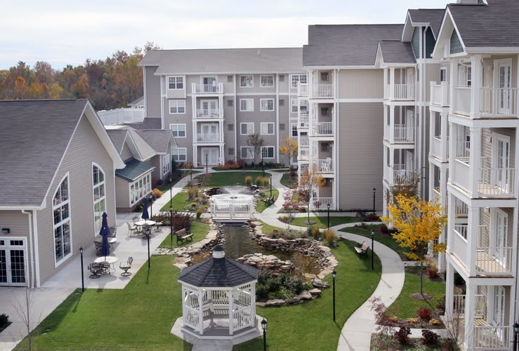 A well-landscaped apartment complex featuring a gazebo and fountain in the courtyard.