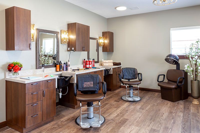 A modern barber shop interior with styling chairs and mirrors.