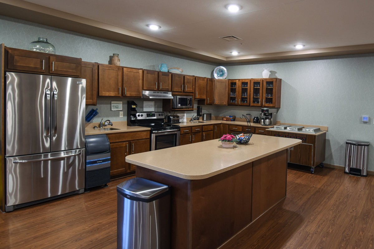 A spacious kitchen with a central island and modern appliances.