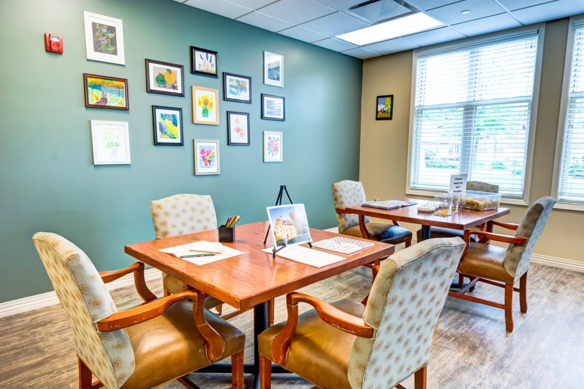 A well-decorated office meeting room with wall art and natural lighting.