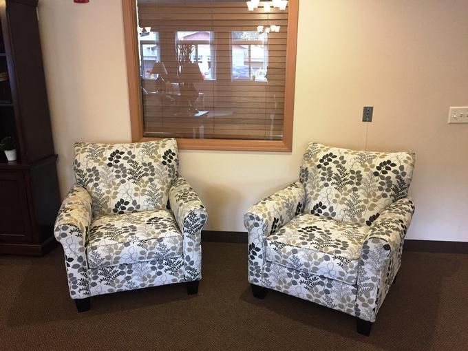 Two floral patterned armchairs facing each other in a cozy room.